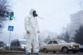 Ecologist in protective suit standing on the street.