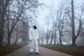 Ecologist in protective uniform standing on the street.