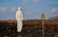 Ecologist standing in field with burnt grass. Royalty Free Stock Photo