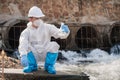 Ecologists examine wastewater with pH test results of water discharged from sewers of refineries into nature to prevent chemical