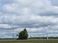 Ecology concept: Blue sky, white clouds and wind turbine. Wind generator for electricity, alternative energy source. Royalty Free Stock Photo