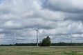 Ecology concept: Blue sky, white clouds and wind turbine. Wind generator for electricity, alternative energy source. Royalty Free Stock Photo