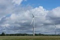 Ecology concept: Blue sky, white clouds, wind turbine and crop field. Wind generator for electricity, alternative energy source. Royalty Free Stock Photo