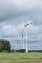 Ecology concept: Blue sky, white clouds, wind turbine and crop field. Wind generator for electricity, alternative energy source. Royalty Free Stock Photo