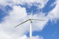 Ecology concept: Blue sky, white clouds and wind turbine. Wind generator for electricity, alternative energy source. Royalty Free Stock Photo