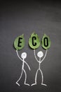 Ecology concept. Chalk drawing people with fresh leaves with word eco on blackboard or chalkboard background