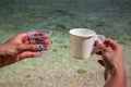 Ecology concept, the fight against plastic, in female hands two glasses - plastic and paper