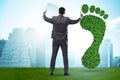 Ecology concept with green footprint and businessman