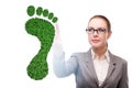 Ecology concept with green footprint and businesswoman