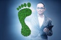 Ecology concept with green footprint and businesswoman