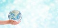 Ecology Concept : Hand holding blue planet earth globe with blurred bokeh background. Royalty Free Stock Photo