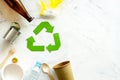 Recycling symbol and different garbage on marble background top view copyspace Royalty Free Stock Photo