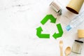 Recycling symbol and different garbage on marble background top view copyspace Royalty Free Stock Photo