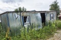 Ecology. The abandoned broken-down construction booth was overgrown with grass.