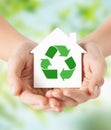 Hands holding house with green recycling sign Royalty Free Stock Photo