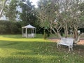 White gazebo and bench in the park