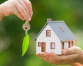 Ecology house and key in hands Royalty Free Stock Photo