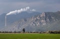 Ecology pollution. White steam comes from the pipe. Industry factory on the field. Landscape background.