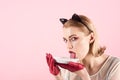 Ecology product and heath. Cat woman eat sour cream. Girl in kitten ears and red gloves with yoghurt on pink background Royalty Free Stock Photo