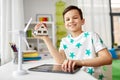 Boy with tablet, toy house and wind turbine Royalty Free Stock Photo