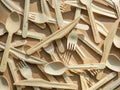 Eco friendly disposable kitchenware utensils on craft paper background. Wooden forks, knives and spoons. Ecology, zero