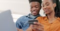 Ecommerce, credit card online shopping and couple on sofa with laptop. Computer, payment and smile, Black man and woman Royalty Free Stock Photo