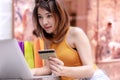 Ecommerce and Shopping online concept. woman holding credit card with shopping bag and purchase order using laptop computer Royalty Free Stock Photo