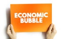 Economic Bubble is a period when current asset prices greatly exceed their intrinsic valuation, text concept on card for