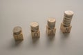 Coins money stack on wooden cubes on a table concept