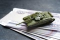 Economic crisis in Russia concept. Toy military tank on Russian rubles. War conflict in Ukraine, economic sanctions and