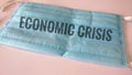 Economic crisis written on medical mask, financial crisis concept for corona virus covid19 pandemic situation in the world