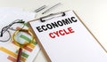 ECONOMIC CYCLE text on clipboard on white background, business concept Royalty Free Stock Photo