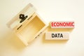 Economic data symbol. Concept words Economic data on wooden block. Beautiful white table white background. Empthy opened wooden