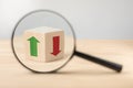 Economic growth and decline analysis. Magnifying glass and wooden cube with green and red arrow. Business analysis concept,