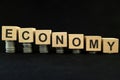 Economic recession, crash, collapse, crisis and economy down concept. Wooden blocks in with coins Royalty Free Stock Photo