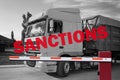 Economic sanctions. Truck on road in front of closed boom barrier. White and black toned design