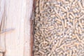 Wood pellets and a log of wood with a blurred background Royalty Free Stock Photo