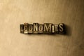 ECONOMIES - close-up of grungy vintage typeset word on metal backdrop