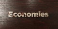 Economies - grungy wooden headline on Maple - 3D rendered royalty free stock image
