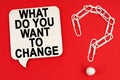 On a red background are a question mark made of paper clips and a sign with the inscription - WHAT DO YOU WANT TO CHANGE