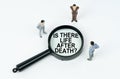 On a white background, figures of businessmen and a magnifying glass with the inscription - IS THERE LIFE AFTER DEATH