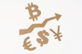 On a white surface, an arrow pointing up and symbols of bitcoin, dollar, euro, yen