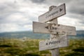 economy, law and politics text on wooden signpost outdoors