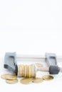 Economy pressure concept with stack of coins in a cramp Royalty Free Stock Photo