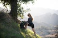 Ecotourism concept. Woman hiker hiking with backpack at hills. Tourist girl climb climbing in mountains with backpacking