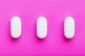 Ecstasy pills in a row on a pink background, isolate Royalty Free Stock Photo