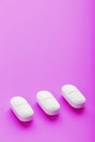 Ecstasy pills in a row on a pink background, isolate. Royalty Free Stock Photo