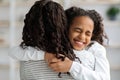 Ecstatic african american school girl hugging her mother Royalty Free Stock Photo