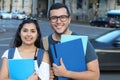 Ecstatic couple of ethnic international students abroad