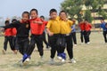Ecstatic school students competing in three legged race